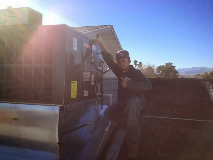 HVAC technician performing HVAC Inspection on a rooftop unit in Goleta